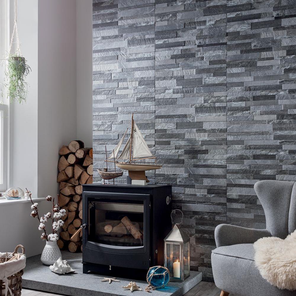 Living room setting with black log burner and fully tiled chimney breast in tiffany grey tiles.