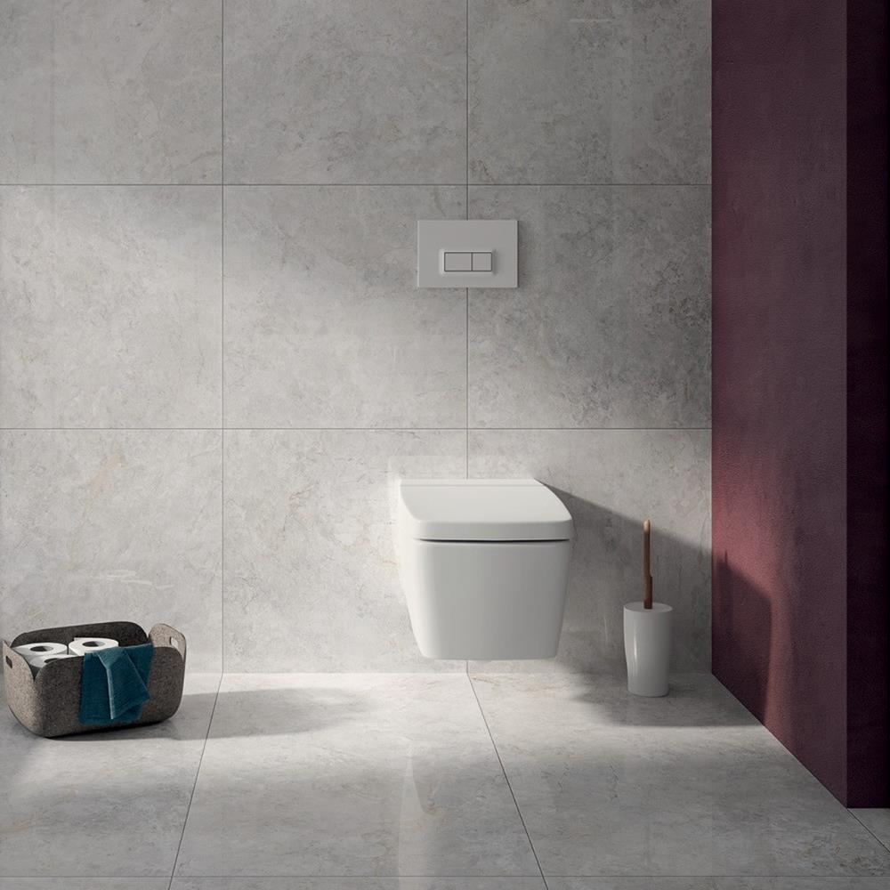 The Marmori 1200x600 tile in a bathroom setting with wall mounted bathroom suite and accent pink wall