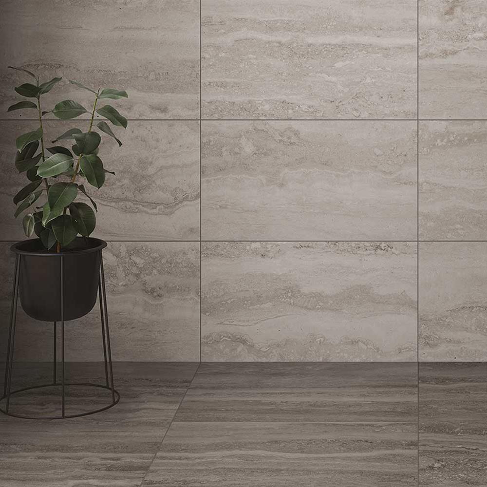 Brescia Grey Travertine Effect Tile shown on floor with plant